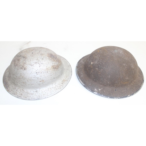 1449O - 4 assorted WW2 period British military Brodie helmets, 1943 dated brass shell case etc