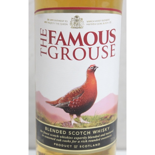 1550 - 2 bottles of Whisky, Tullamore Dew 1 litre and Famous Grouse 70cl (2)