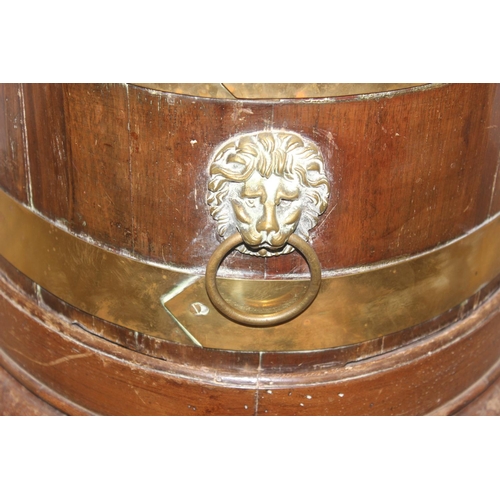 71 - A George III mahogany oval and brass bound wine cooler, circa 1780, now as a jardiniere, with lions ... 