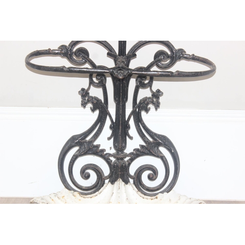 141 - A 19th century cast iron stick stand with drip tray, both pieces with various marks to inc the Victo... 