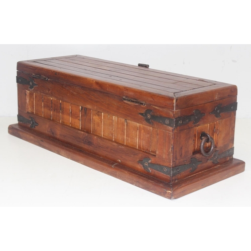 299 - A vintage stained pine trunk with iron fittings, approx 61cm wide