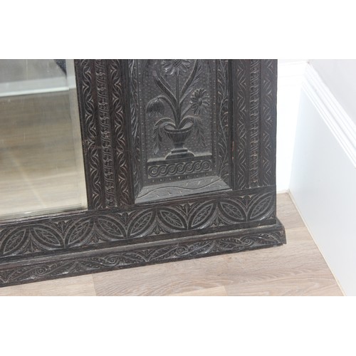 366 - A 19th century Gothic Revival carved oak over-mantel or wall mirror, a projecting cornice over friez... 