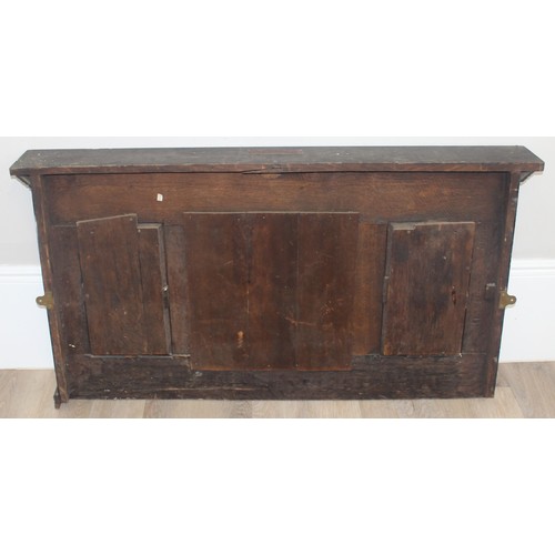 366 - A 19th century Gothic Revival carved oak over-mantel or wall mirror, a projecting cornice over friez... 