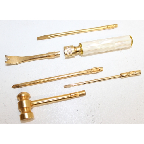 718 - An interesting brass miniature tool kit with five interchangeable tool heads and mother of pearl han... 