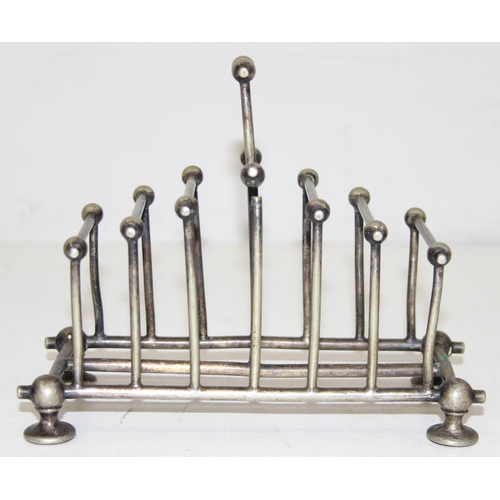 1007 - An antique silver plated 6 slice toast rack in the manner of Christopher Dresser, marked for Benetfi... 