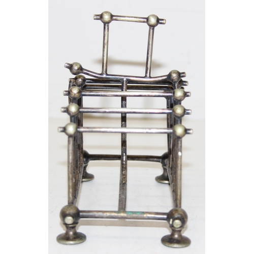 1007 - An antique silver plated 6 slice toast rack in the manner of Christopher Dresser, marked for Benetfi... 