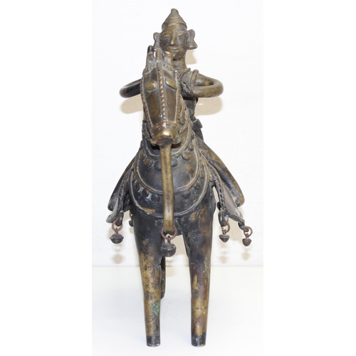 1406 - A large cast metal figure of a horse and rider, possibly South Indian, made from a bronze-like coppe... 