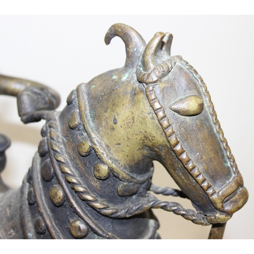 1406 - A large cast metal figure of a horse and rider, possibly South Indian, made from a bronze-like coppe... 