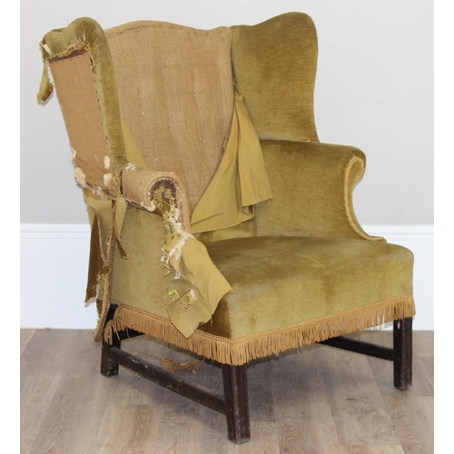 136 - An antique wing back armchair with green gold partial upholstery, likely George III period c.1800, e... 