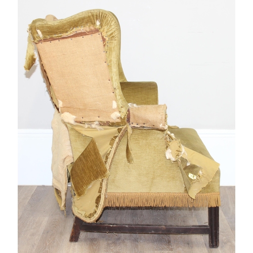 136 - An antique wing back armchair with green gold partial upholstery, likely George III period c.1800, e... 