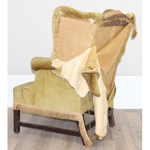 136 - An antique wing back armchair with green gold partial upholstery, likely George III period c.1800, e... 