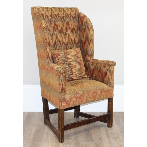 82 - A very unusual antique wing back armchair with patterned gold upholstery, exposed oak legs, believed... 