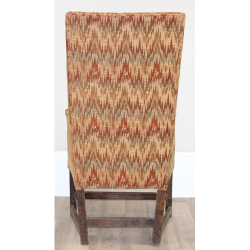 82 - A very unusual antique wing back armchair with patterned gold upholstery, exposed oak legs, believed... 