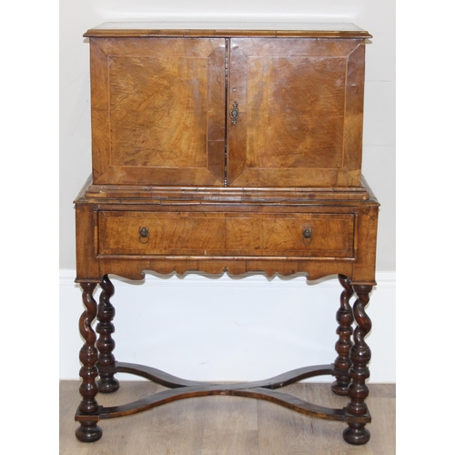 12 - An antique walnut veneered cabinet on stand, believed to be late 17th or early 18th century, the bas... 