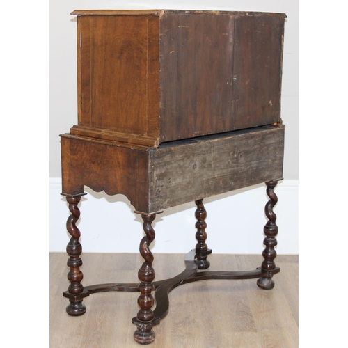 12 - An antique walnut veneered cabinet on stand, believed to be late 17th or early 18th century, the bas... 