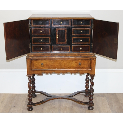 12 - An antique walnut veneered cabinet on stand, believed to be late 17th or early 18th century, the bas... 