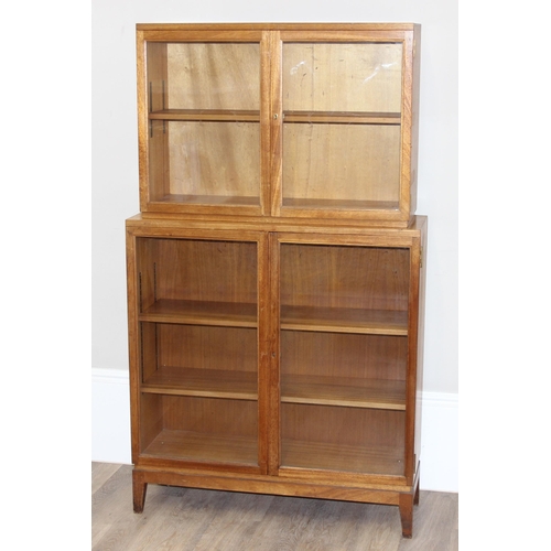 39 - Gordon Russell of Broadway, a 1955 dated glazed 2 section bookcase with adjustable shelves, marked v... 