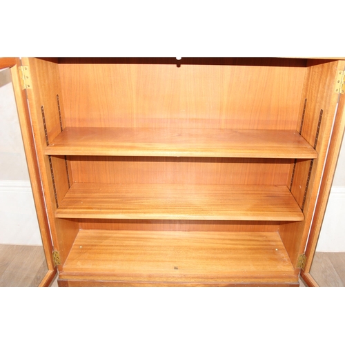 39 - Gordon Russell of Broadway, a 1955 dated glazed 2 section bookcase with adjustable shelves, marked v... 