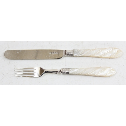 1018 - A boxed set of silver bladed and pronged fruit knives and forks with twist carved mother of pearl ha... 