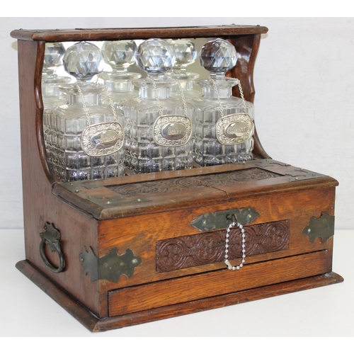 274 - Vintage 3-decanter tantalus with mirrored back, hidden games drawer, and decanter labels for sherry,... 