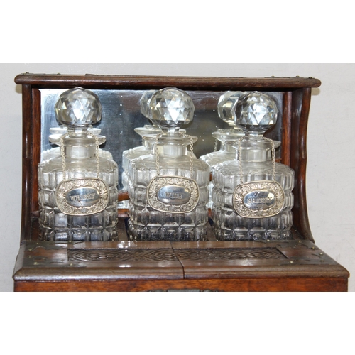 274 - Vintage 3-decanter tantalus with mirrored back, hidden games drawer, and decanter labels for sherry,... 