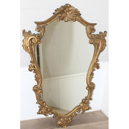 366 - An antique style Rococo designed shield shaped wall mirror with gilt frame, approx 74cm x 54cm