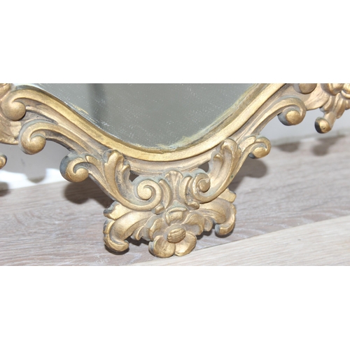 366 - An antique style Rococo designed shield shaped wall mirror with gilt frame, approx 74cm x 54cm