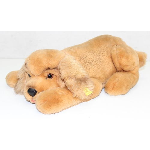 609 - Steiff stuffed dog with original button in ear and red collar, approx 43cm nose-to-tail