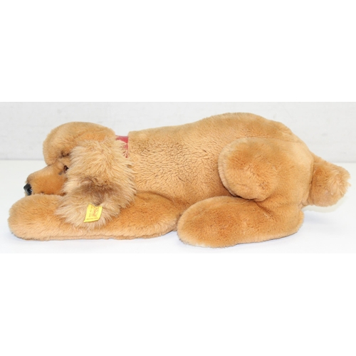 609 - Steiff stuffed dog with original button in ear and red collar, approx 43cm nose-to-tail