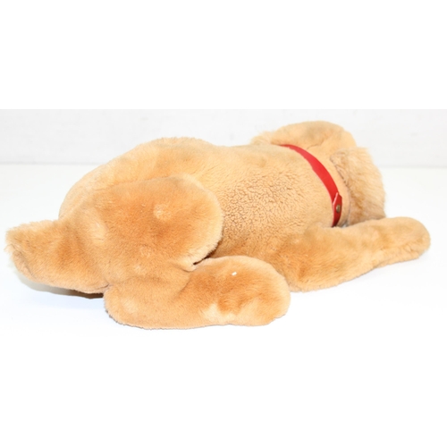 609 - Steiff stuffed dog with original button in ear and red collar, approx 43cm nose-to-tail