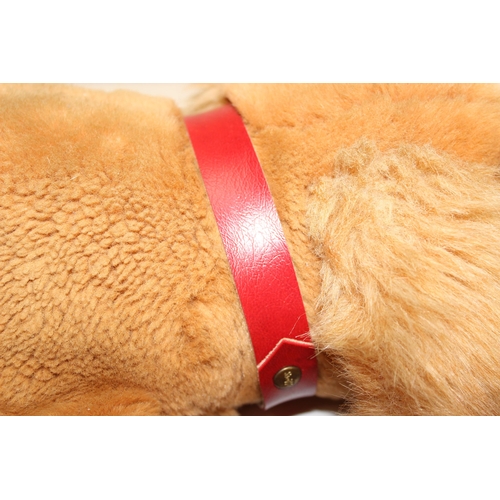 609 - Steiff stuffed dog with original button in ear and red collar, approx 43cm nose-to-tail