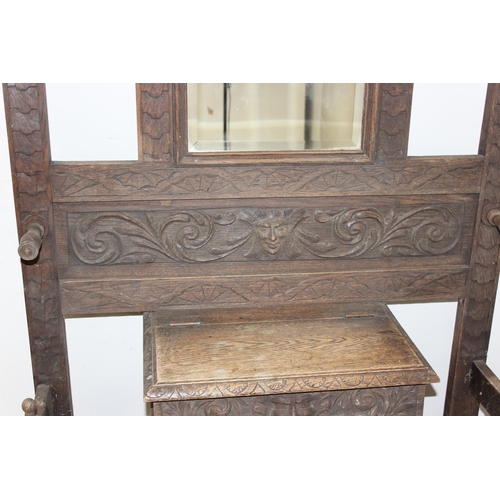 78 - Antique carved oak hallstand with Green Man mask decoration, approx 103cm x 30cm x 189cm