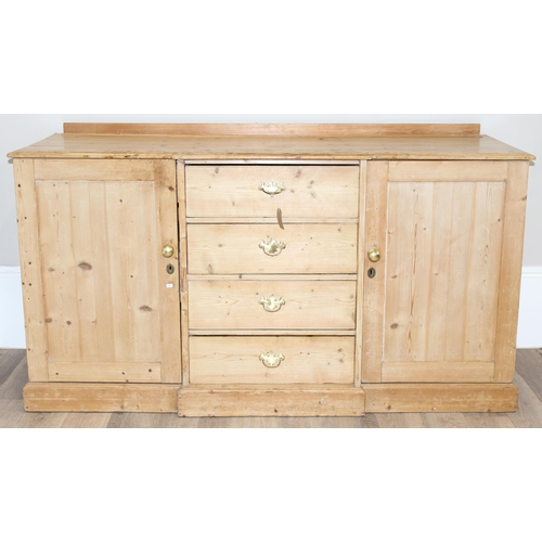 5 - A Victorian pine sideboard with 4 central drawers flanked by 2 cupboards, all with brass fittings, a... 