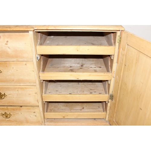 5 - A Victorian pine sideboard with 4 central drawers flanked by 2 cupboards, all with brass fittings, a... 