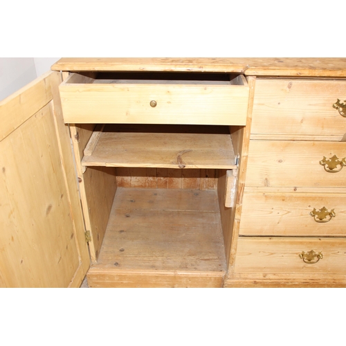 5 - A Victorian pine sideboard with 4 central drawers flanked by 2 cupboards, all with brass fittings, a... 