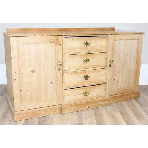 5 - A Victorian pine sideboard with 4 central drawers flanked by 2 cupboards, all with brass fittings, a... 