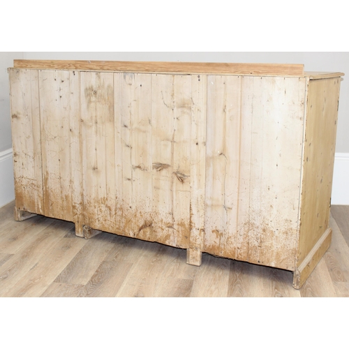 5 - A Victorian pine sideboard with 4 central drawers flanked by 2 cupboards, all with brass fittings, a... 