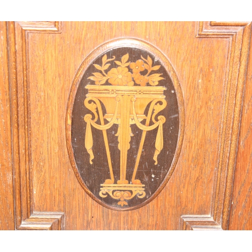 107 - An early 20th century oak desk with bureau top, 2 drawers to base under a fall front cupboard with 2... 