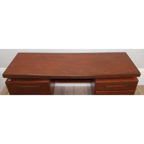 103 - A retro G-Plan desk or dressing table base with 2 pairs of drawers flanking a hidden drawer to centr... 