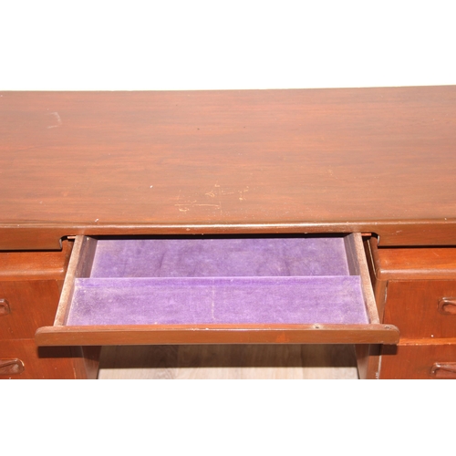 103 - A retro G-Plan desk or dressing table base with 2 pairs of drawers flanking a hidden drawer to centr... 