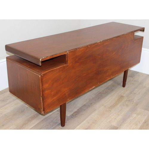 103 - A retro G-Plan desk or dressing table base with 2 pairs of drawers flanking a hidden drawer to centr... 