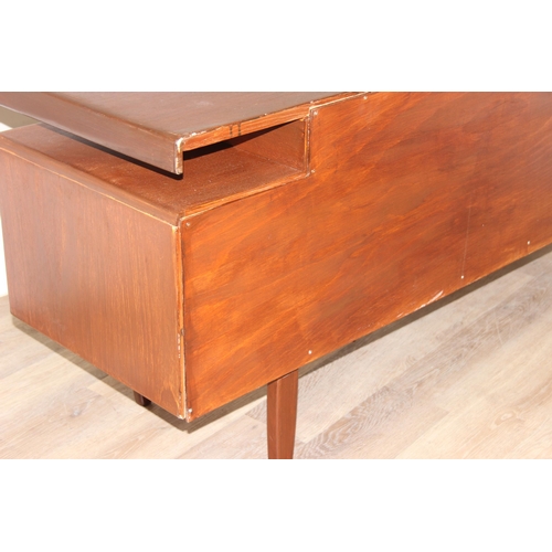 103 - A retro G-Plan desk or dressing table base with 2 pairs of drawers flanking a hidden drawer to centr... 