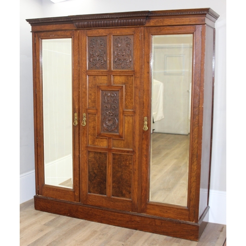 59 - An antique oak and burr wood wardrobe or hall cupboard with carved central panels and 3 doors, the 2... 