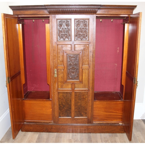 59 - An antique oak and burr wood wardrobe or hall cupboard with carved central panels and 3 doors, the 2... 