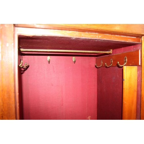 59 - An antique oak and burr wood wardrobe or hall cupboard with carved central panels and 3 doors, the 2... 