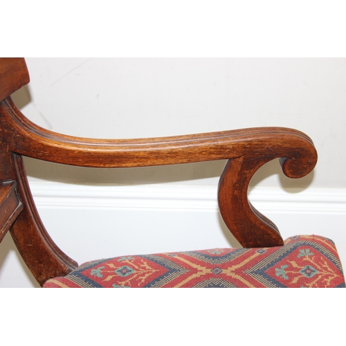 117 - A 19th century mahogany scroll arm carver or library chair, T.R. Roberts of Islington ivorine plaque... 