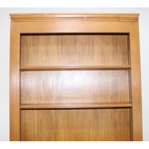 175 - A large modern stained pine bookcase with 6 adjustable shelves, approx 85cm wide x 27cm deep x 232cm... 