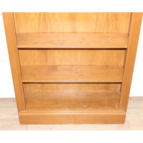 175 - A large modern stained pine bookcase with 6 adjustable shelves, approx 85cm wide x 27cm deep x 232cm... 