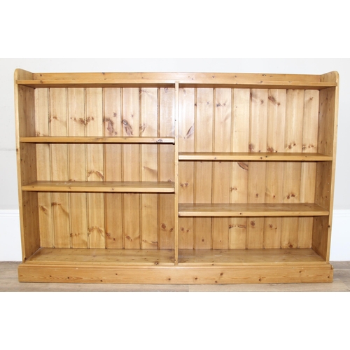 143 - A modern pine bookcase with 2 sections and 4 adjustable shelves, approx 180cm wide x 26cm deep x 123... 