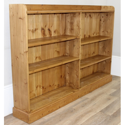 143 - A modern pine bookcase with 2 sections and 4 adjustable shelves, approx 180cm wide x 26cm deep x 123... 